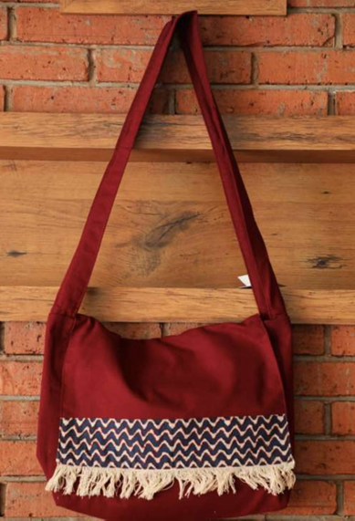 Maroon bag with a zigzag pattern and fringes